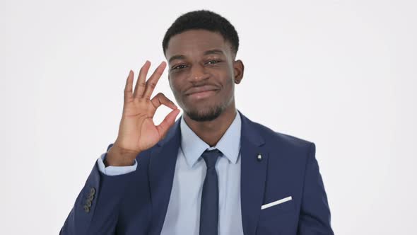 African Businessman Showing Okay Sign on White Background