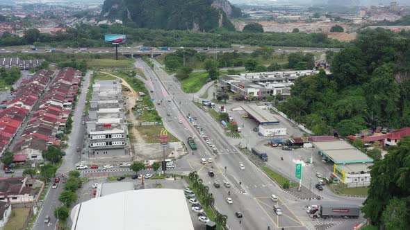 Birds eye view overlooking at traffics on major road Jalan. Kuala Kangsar, tilt up reveals extruded