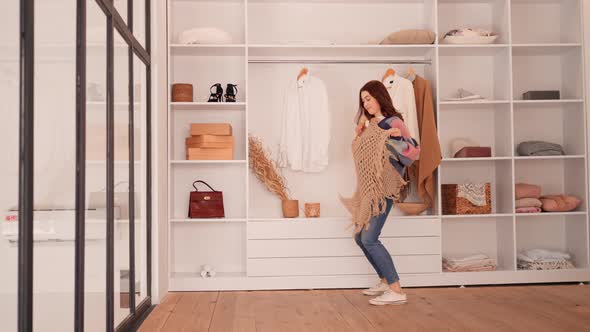 Cheerful Female Trying on Outfits in Wardrobe