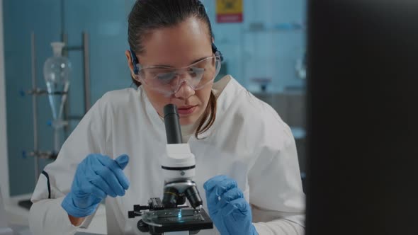 Portrait of Scientist Analyzing Liquid Sample on Microscope Tray