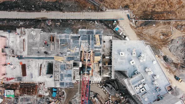 Camera Raises Above Roof of Apartment Building and Cranes