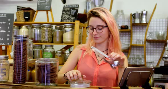 Woman packing cookies in cafe 4k