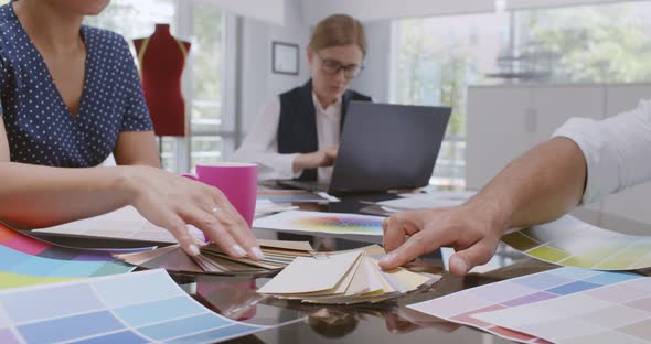 Cropped Shot of Fashion Designers Looking at Color Swatches at Meeting in Office