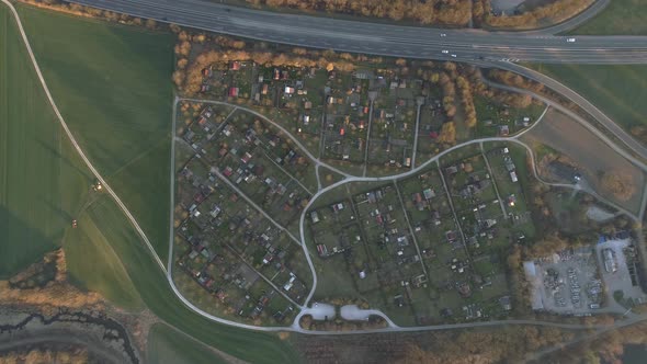 Drone flying over plantation Tractor Crop Field and a Garden community