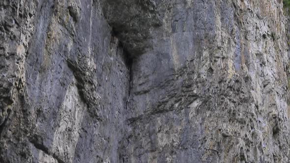 A man rock climbing up a mountain.