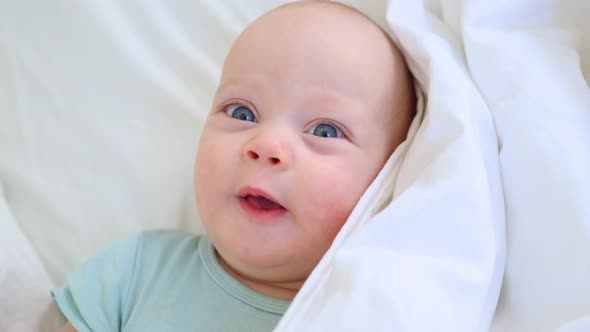 Beautiful Blue Eyed Infant Baby Portrait Closeup Smiling Face of Little Child