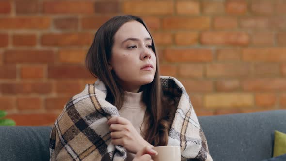 Young Depressed Woman Drinking Tea Sitting Alone Home Wrapped Plaid Slow Motion