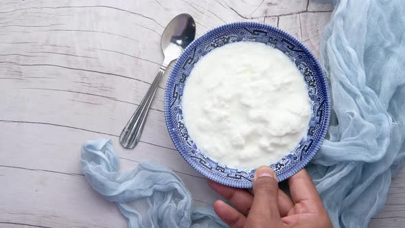 Top View of Man Hand Scooping Yogurt