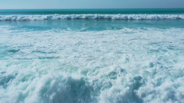 Low Flight Over the Sandy Beach and Waves