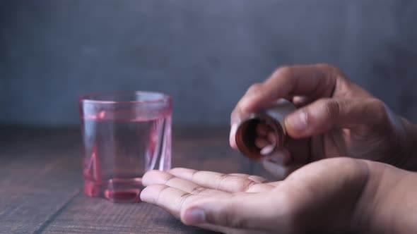 Close Up of Man Hand Taking Medicine 