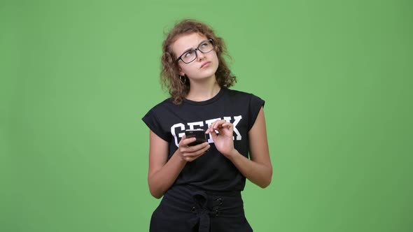 Young Happy Beautiful Nerd Woman Thinking While Using Phone