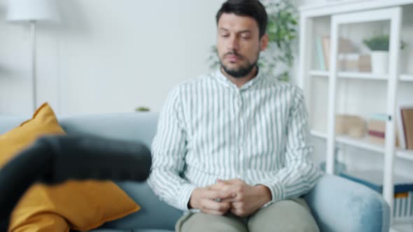 Zoomin Portrait of Lonely Disabled Guy Crying Looking at Wheelchair Suffering From Depression