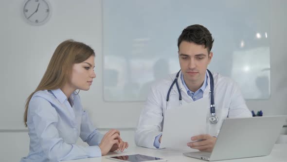 Doctor Sharing Good News with Patient Holding Medical Report