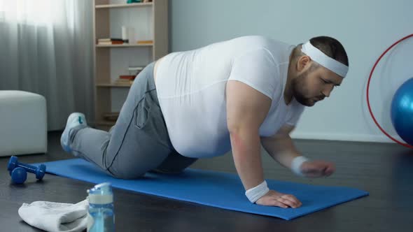 Fat Man Practicing Plank Exercise on Mat During Home Workout, Will Power, Goal