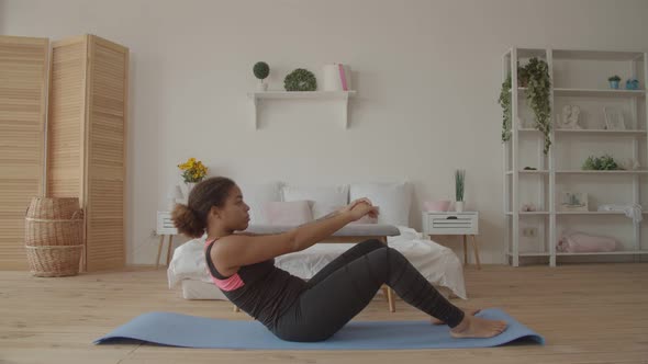 Determined Fitness Woman Doing Sit-ups at Home