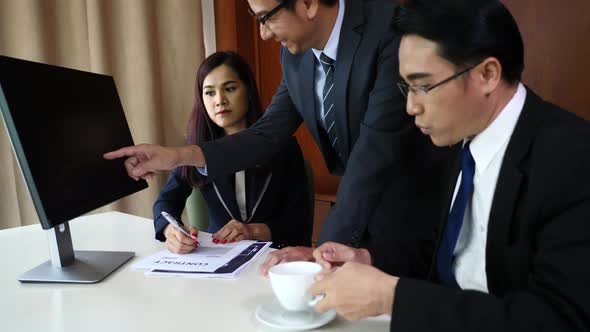 Business people group working together at office desk and checking a financial report.