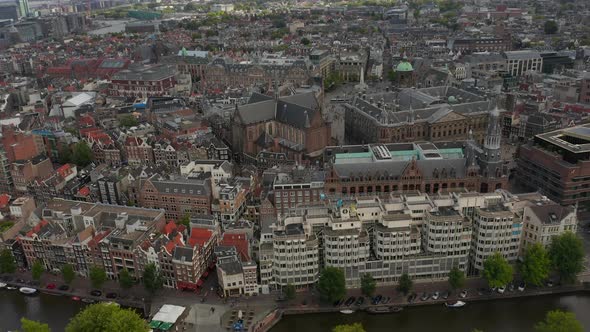 Slow Forward Aerial Establisher of Amsterdam Cityscape and Royal Palace on Cloudy Day