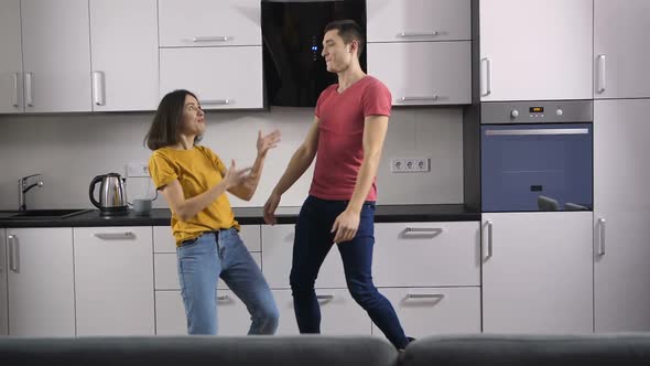 Young People Dancing Listening To Music at Home