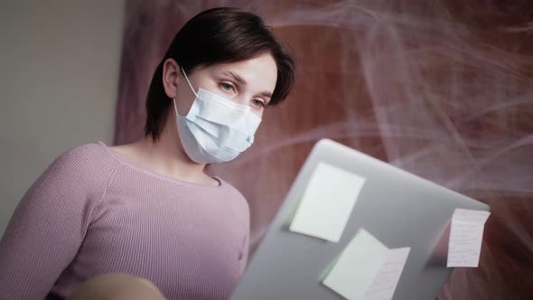 Young Freelancer Woman Working on Laptop at Home