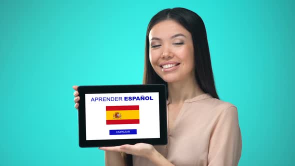 Female Holding Tablet With Learn Spanish Application, Ready to Start Course