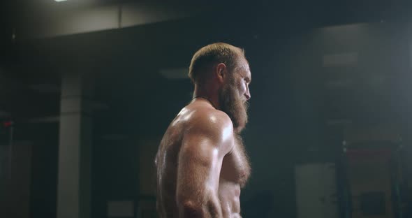 Tired Bearded Man with Vapor on Body in the Gym Recovers After Workout