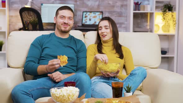 Cheerful Bearded Man Laughing While Watching a Movie