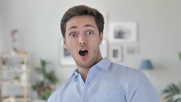 Amazed Handsome Young Man Surprised By Positive Events