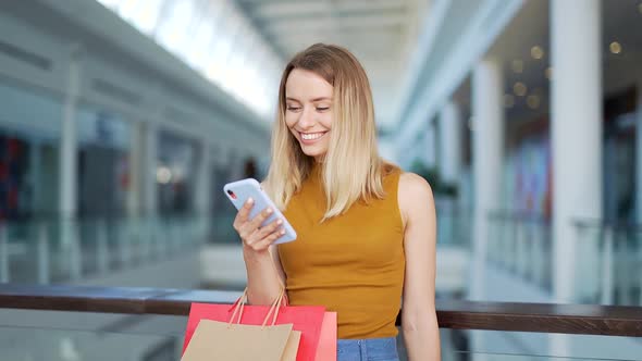 young happy after shopping woman talking on cell in mall.