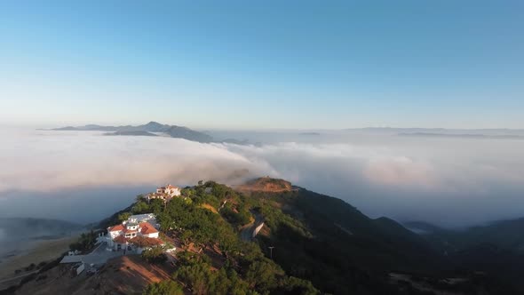 Houses along the canyon above the morning clouds in Malibu Canyon, Monte Nido, California, USA