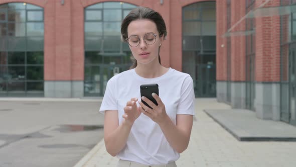 Beautiful Woman Browsing Internet on Smartphone