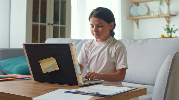 Schoolgirl Chatting on Webcam While Preparing for a Test or Exam with an Online Teacher