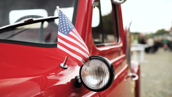 Close Side View Of Red Pickup Truck With Small American Flag Waving In Slomo Slow Motion