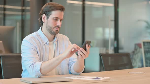 Mature Adult Man Using Phone in Office