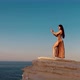 Woman Dancing on Rocks Near Sea - VideoHive Item for Sale