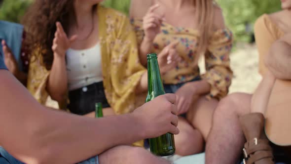 Close up of handsome man drinking beer on the party 