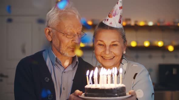 Happy Senior Couple Celebrating Anniversary or Wife Birthday at Home