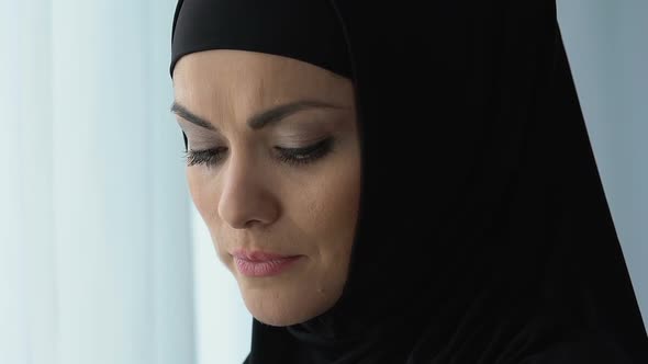 Desperate Muslim Lady in Headscarf Standing Near Window, Crisis and Depression