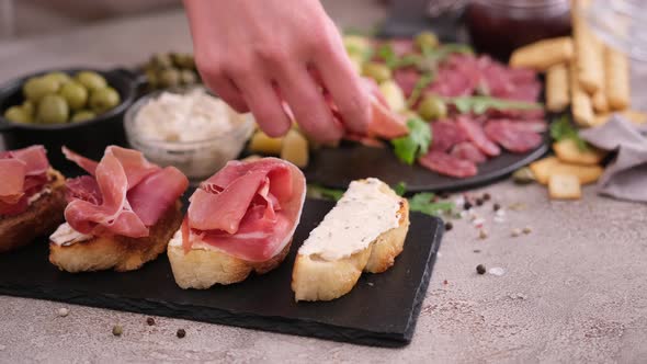 Bruschetta with Prosciutto or Jamon Ham and Cream Cheese on Stone Serving Board