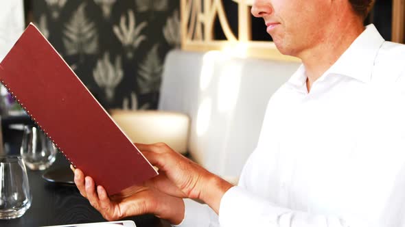 Businessman checking the menu