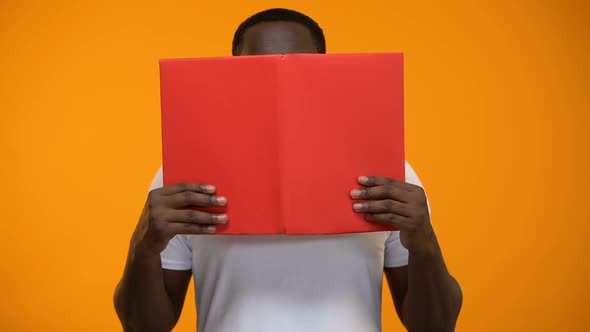 Excited Afro-American Man Reading Book, Studying and Self Development, Close-Up