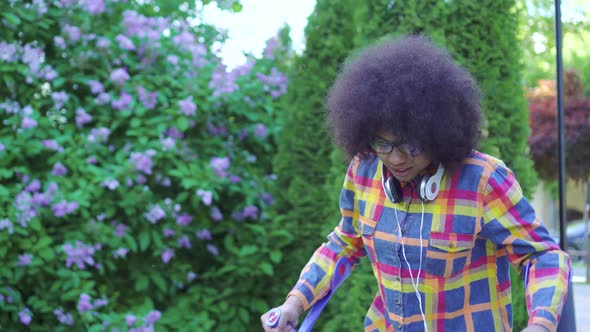 African American Woman with an Afro Hairstyle with a Broken Leg on Crutches Сlose Up