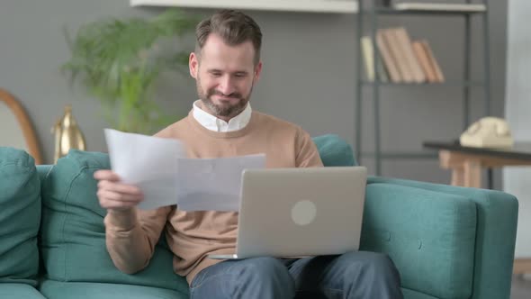 Man with Laptop Celebrating Success on Laptop Sofa