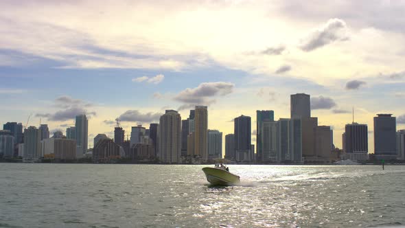 Boat floating in the bay by Miami's towers