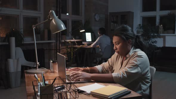 Stressed Out Office Worker In Office At Night