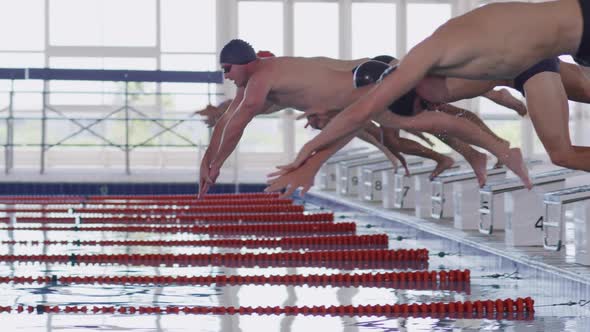 Swimmers diving into the pool