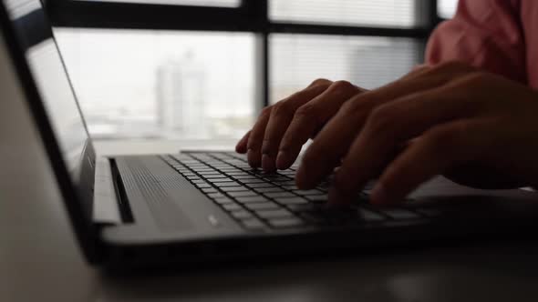 Closeup Side View of Unrecognizable Businessman Sits Down at Desk and Starting Working Typing on