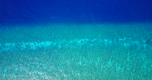 Bright blue turquoise sea texture with calm water over beautiful coral reef and rocky seabed in Mexi