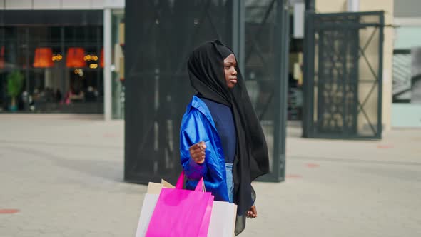 Muslim Shopaholic in Passage Outside Mall