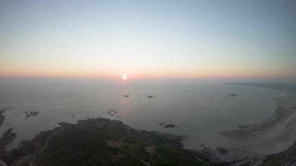 Drone aerial fly away footage of Beauport Beach in Jersey.