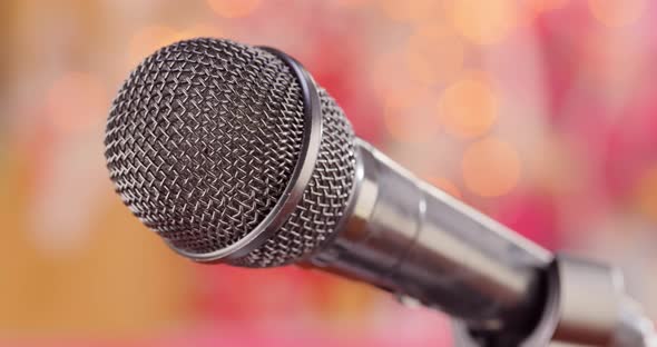 Microphone on Stage Against a Blurry Light ,Blurry Background.